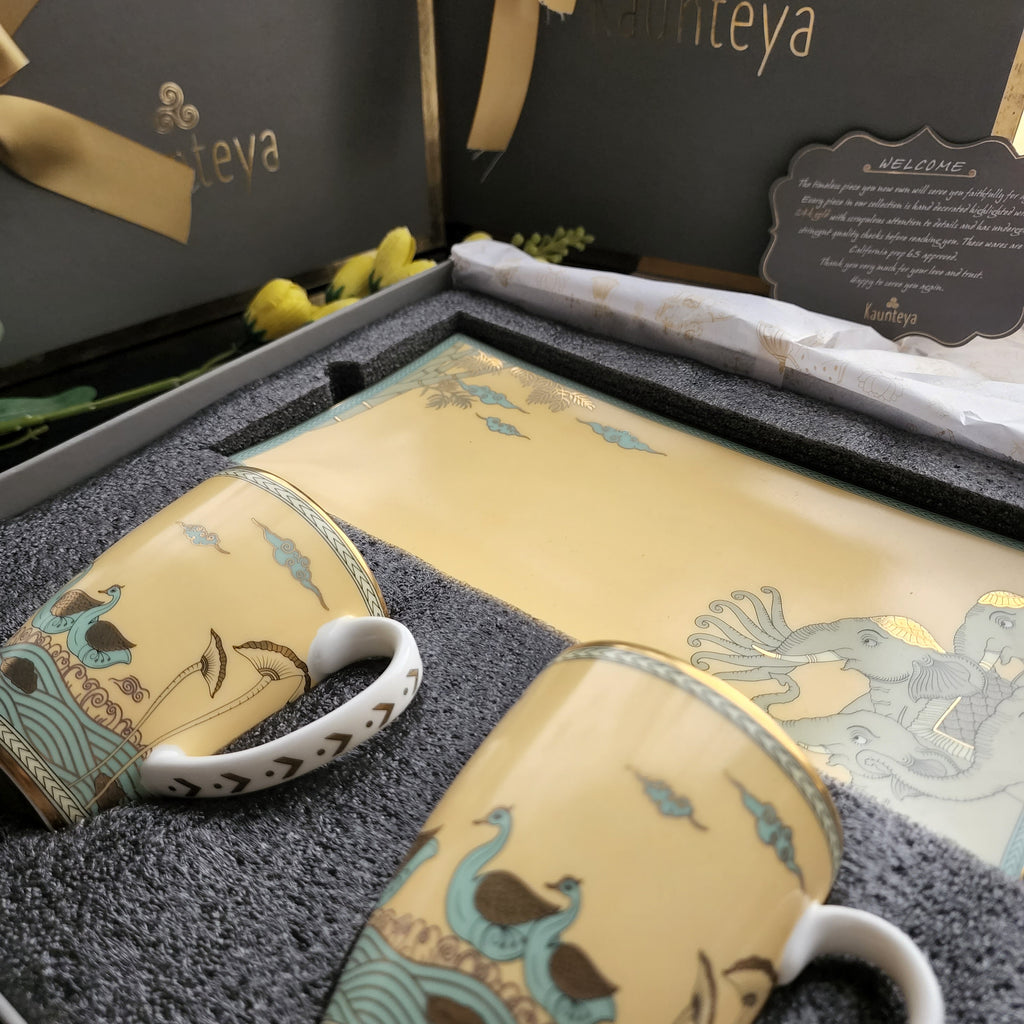 Kaunteya Airavata Premium Gift Set- Lightweight, fine bone china, tableware, luxury cookie plate and 2 yellow coffee mugs with a gift box, 24K gold plated, Pattachitra art, beautiful gold and yellow crockery with intricately designed green and gold swans and elephants.