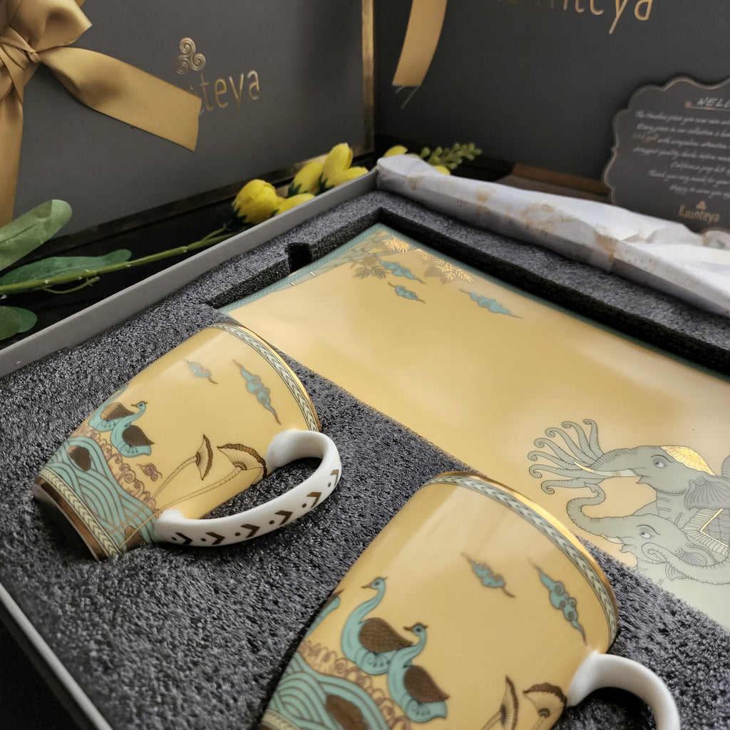 Kaunteya Airavata Premium Gift Set- Lightweight, fine bone china, tableware, luxury cookie plate and 2 yellow coffee mugs with a gift box, 24K gold plated, Pattachitra art, beautiful gold and yellow crockery with intricately designed green and gold swans and elephants.